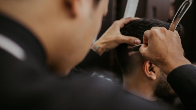 selective focus photography of a barber