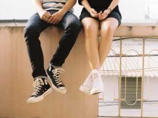 woman wearing white high top shoes
