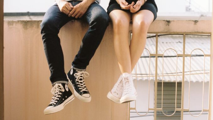 woman wearing white high top shoes