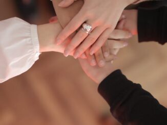 2021's wedding trends - crop friends stacking hands together