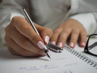 person hands woman pen - setting new goals