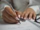 person hands woman pen - setting new goals