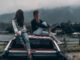two women sitting on vehicle roofs - evolution of fashion