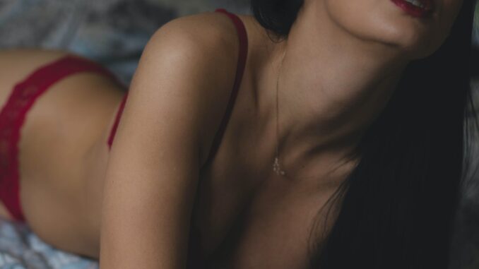 woman lying on bed - Who tops the global sexy search index?