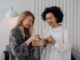two women enjoying a box of beauty products - The UK's Most Popular Beauty Trends