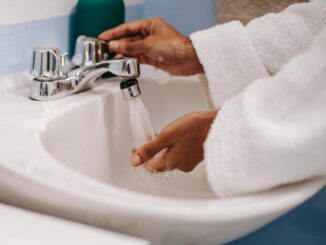 10 Top Tips to Save Water at Home -crop ethnic woman in robe washing hands in bathroom