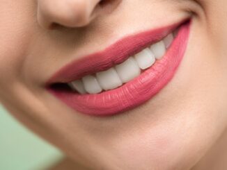 woman with red lipstick smiling - How to get ready for a visit to a dentist