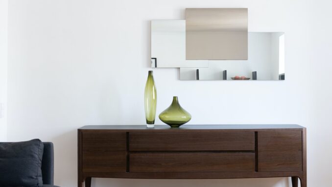 apartment interior with cabinet with vases near mirror