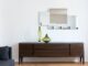apartment interior with cabinet with vases near mirror