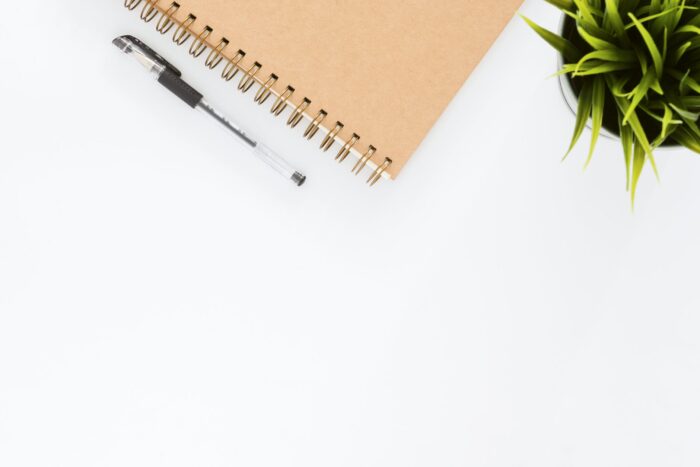6 tips for being successful at budgeting - black ball point pen with brown spiral notebook