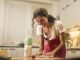 happy woman with rolling pin cooking at home