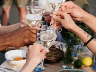 person holding clear wine glass