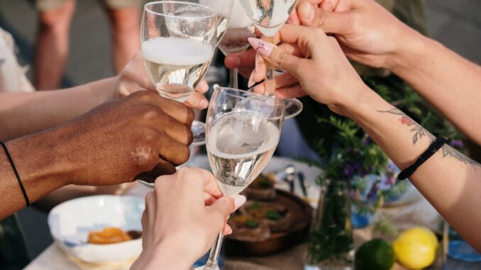 person holding clear wine glass