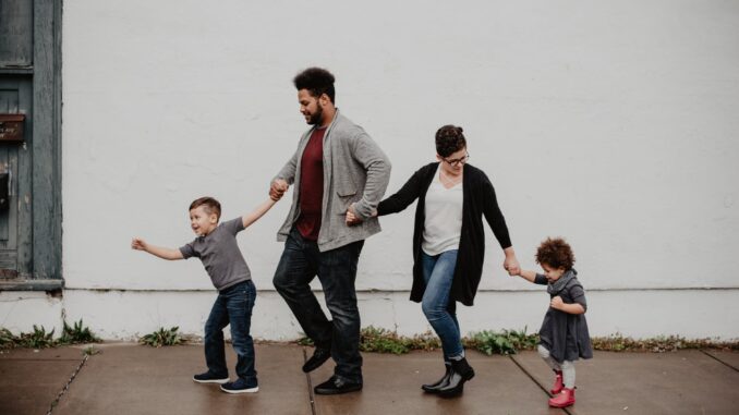 family of four walking at the street
