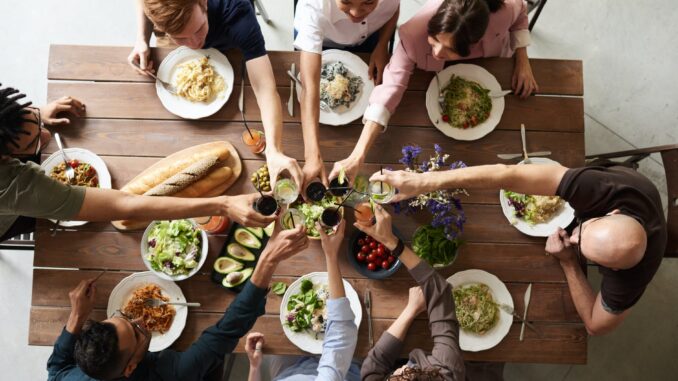 Average UK adult spends nearly £500 on subscription services a year - group of people making toast