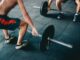 man wearing black shorts lifting heavy barbells - How to start your fitness journey