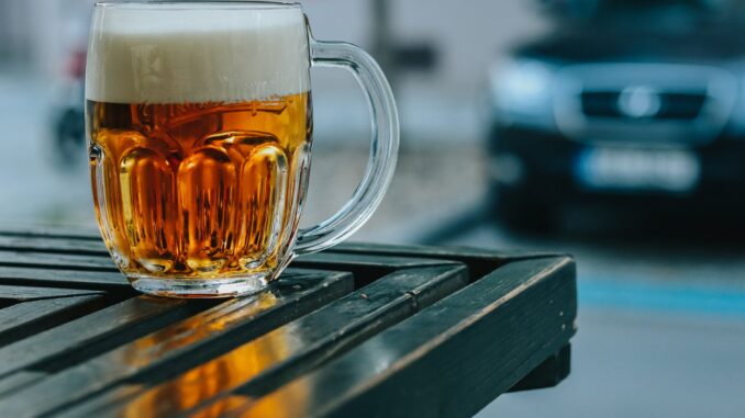 independent breweries - clear glass mug on black wooden table