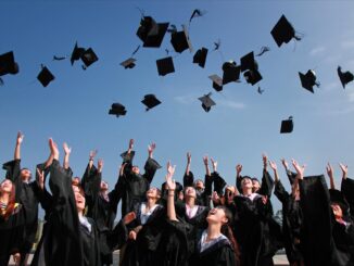 newly graduated people wearing black academy gowns throwing hats up in the air - Google data reveals where the world wants to study the most