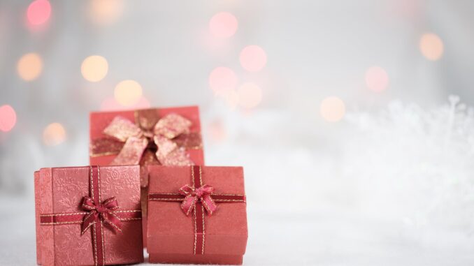 photo of red boxes - Grooming, Travel, & Experience Gifts are 'Most In-Demand' for Christmas 2021