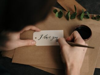 person holding white printer paper - looking for love