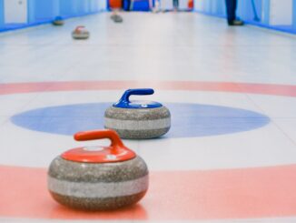 red and blue handled curling stones placed on house - These are the top Olympic sports for Teens