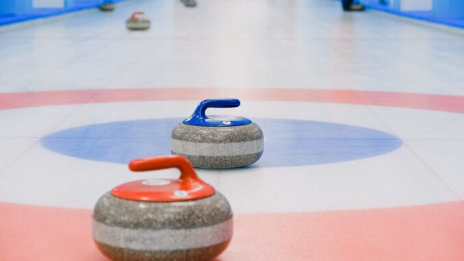 red and blue handled curling stones placed on house - These are the top Olympic sports for Teens