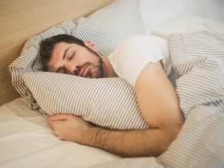 photo of sleeping man - men are getting more sleep