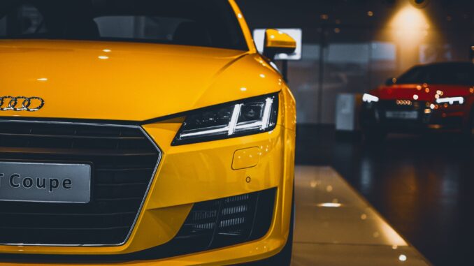 shiny yellow audi car in showroom