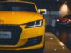 shiny yellow audi car in showroom