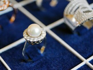white pearl ring on blue surface