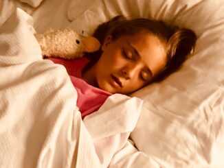 girl sleeping on bed