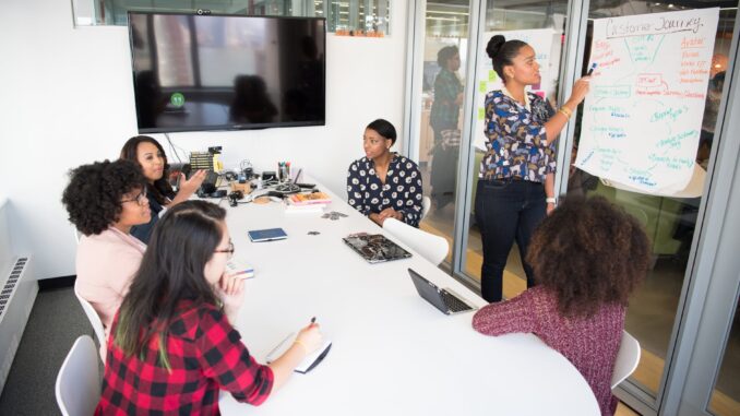 women colleagues gathered inside conference room