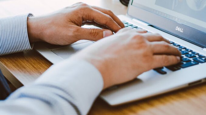 man using dell laptop