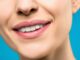 close up photo of woman with pink lipstick smiling